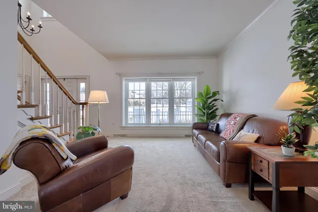 a view of a workspace with furniture and a floor to ceiling window