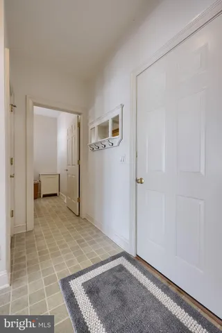 a spacious bedroom with a bed and wooden floor