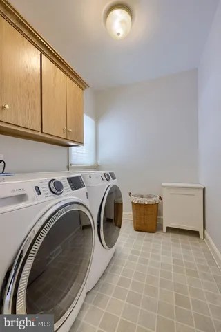 a spacious bedroom with a bed and a dresser