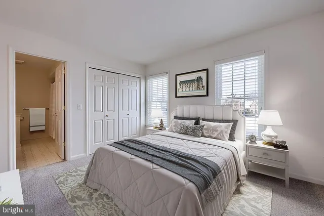 a view of an empty room with wooden floor and stairs
