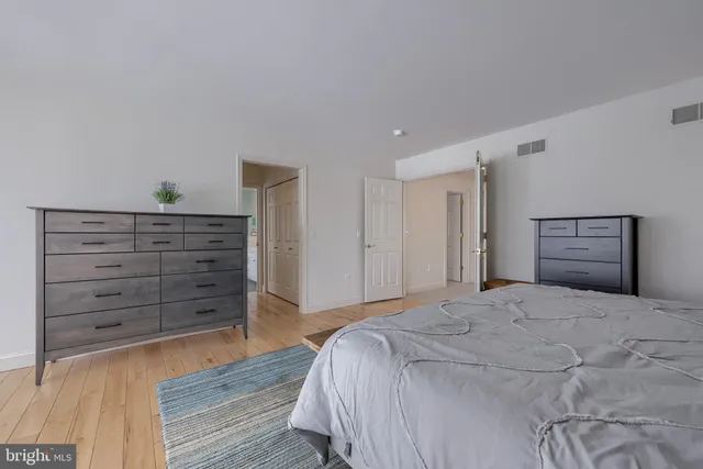 a view of a house with a small yard and a large trees
