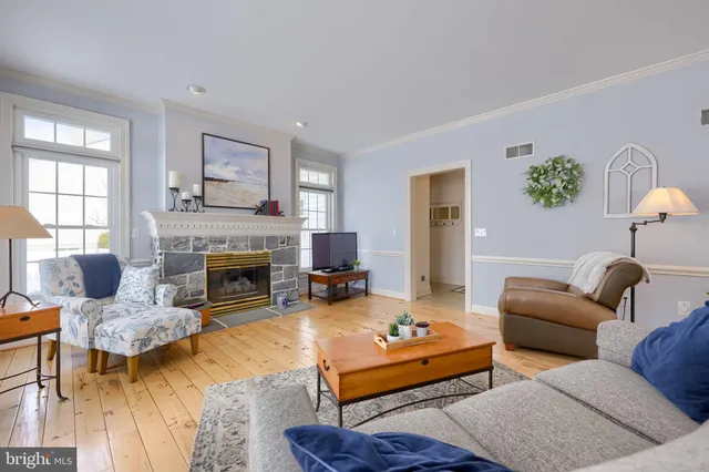 a kitchen that has a lot of white cabinets and stainless steel appliances
