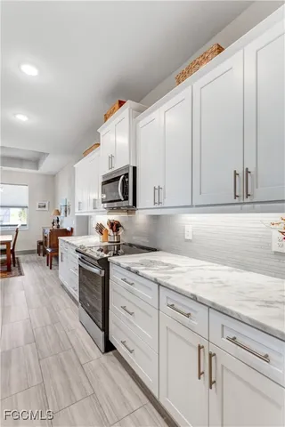 a kitchen with stainless steel appliances granite countertop a sink and cabinets