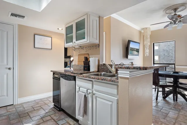 a kitchen with stainless steel appliances a sink stove and cabinets
