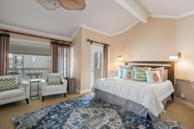 a bedroom with a bed couch and a window