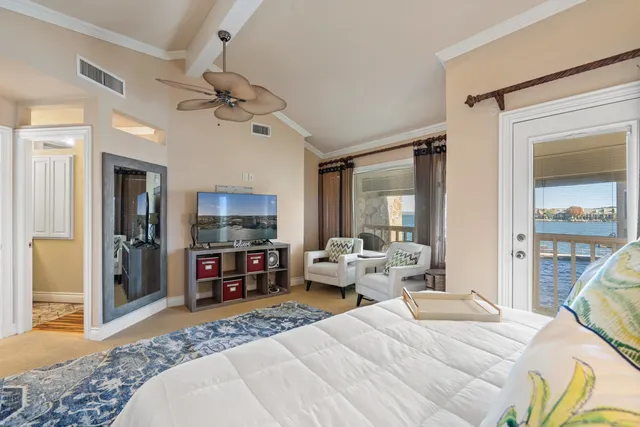 a bedroom with a large bed and a chandelier