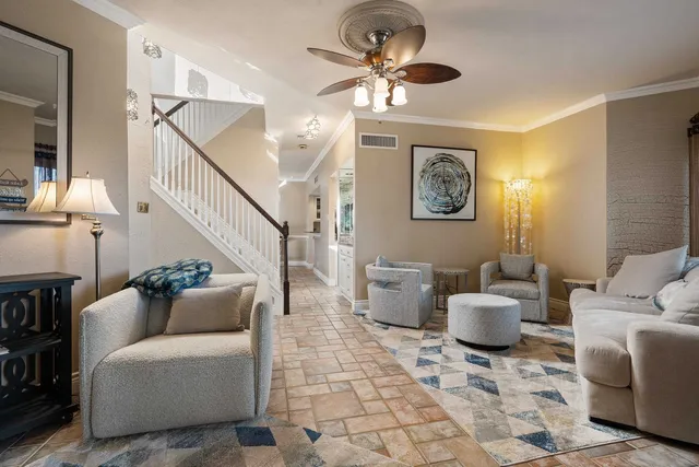 a living room with furniture and a chandelier