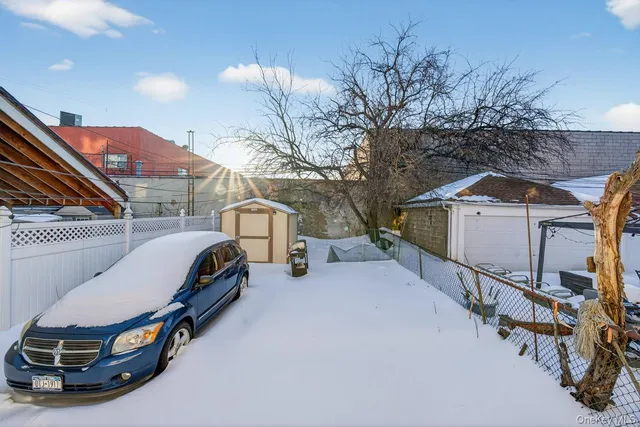 a view of car parked in back yard of house