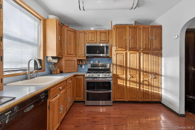 a kitchen with stainless steel appliances a stove sink and microwave