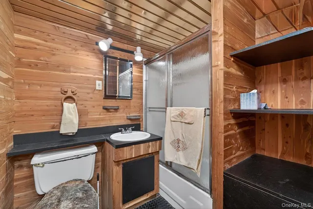 a bathroom with a granite countertop sink and washing machine