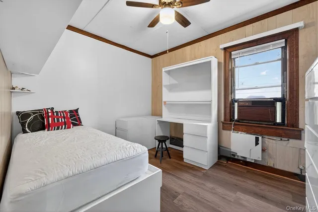 a bedroom with a bed and a television