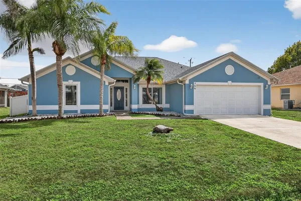 a front view of house with yard and green space