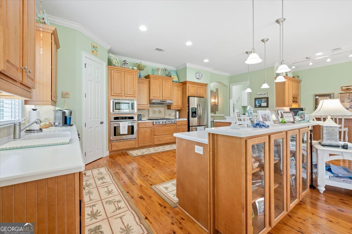 4787 Sunbury Road Midway, GA 31320 - Photo 16 of 72 a view of a kitchen with kitchen island granite countertop lots of counter top space and stainless steel appliances