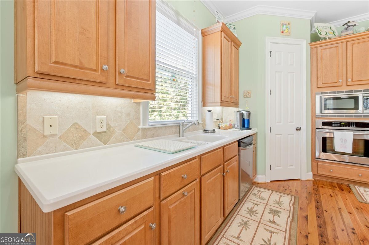 4787 Sunbury Road Midway, GA 31320 - Photo 17 of 72 a kitchen with stainless steel appliances granite countertop a sink and dishwasher with white cabinets