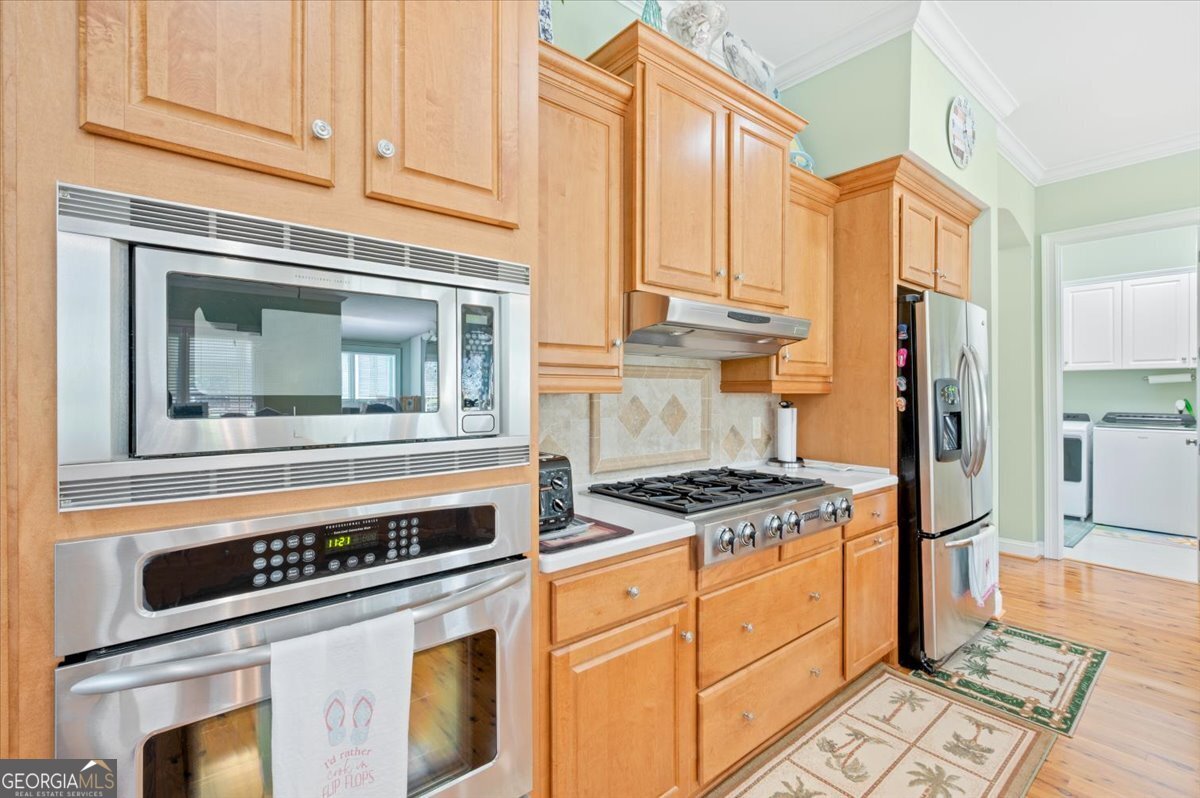 4787 Sunbury Road Midway, GA 31320 - Photo 19 of 72 a kitchen with stainless steel appliances granite countertop a stove a refrigerator and a microwave