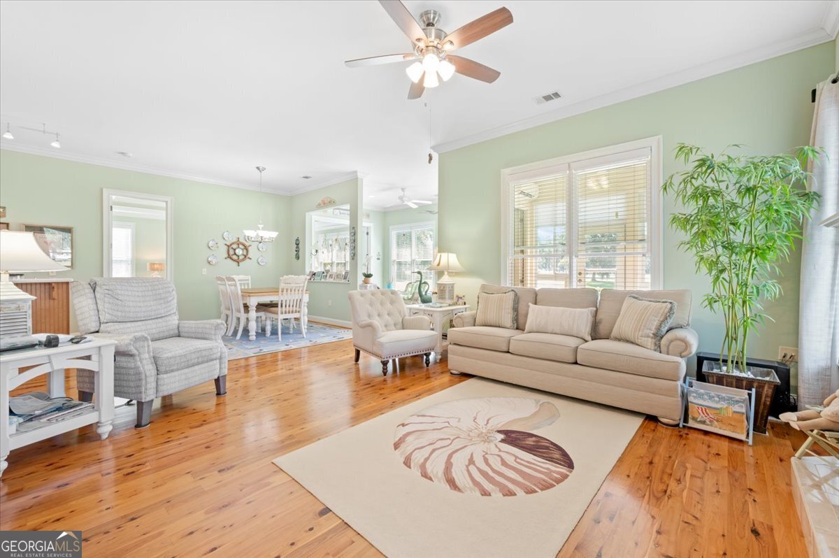 4787 Sunbury Road Midway, GA 31320 - Photo 24 of 72 a living room with furniture wooden floor and a large window