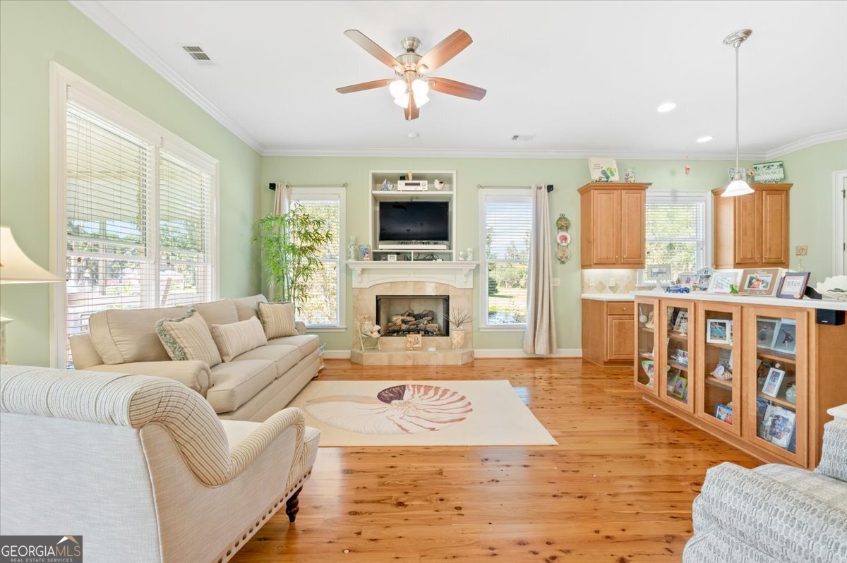 4787 Sunbury Road Midway, GA 31320 - Photo 25 of 72 a living room with furniture fireplace and a flat screen tv