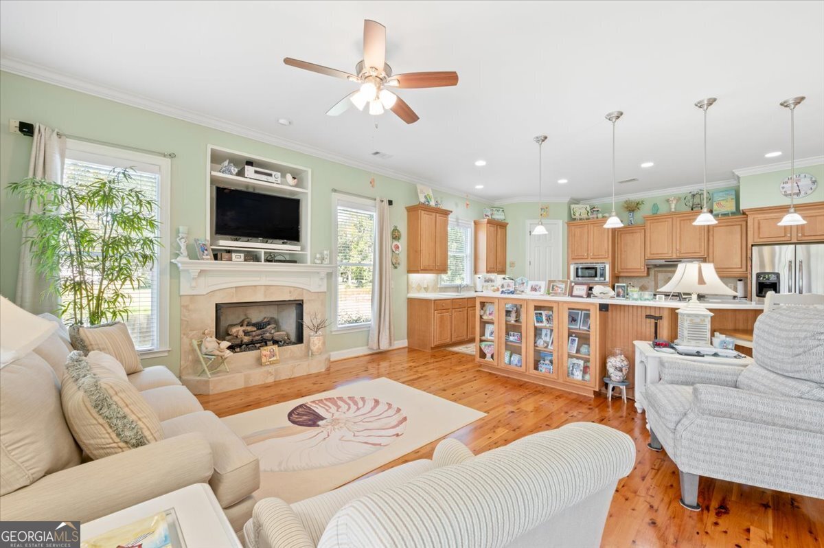4787 Sunbury Road Midway, GA 31320 - Photo 26 of 72 a living room with furniture a fireplace and a flat screen tv