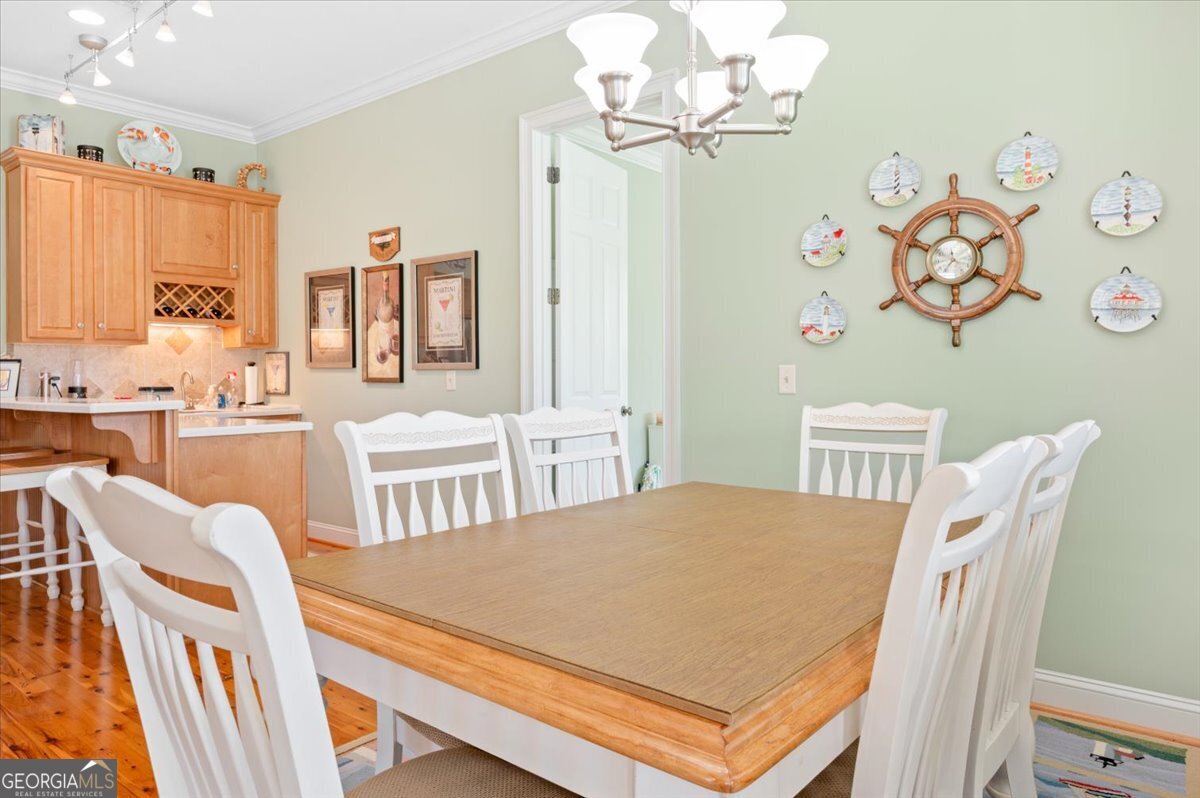 4787 Sunbury Road Midway, GA 31320 - Photo 28 of 72 a view of a dining room with furniture and a chandelier