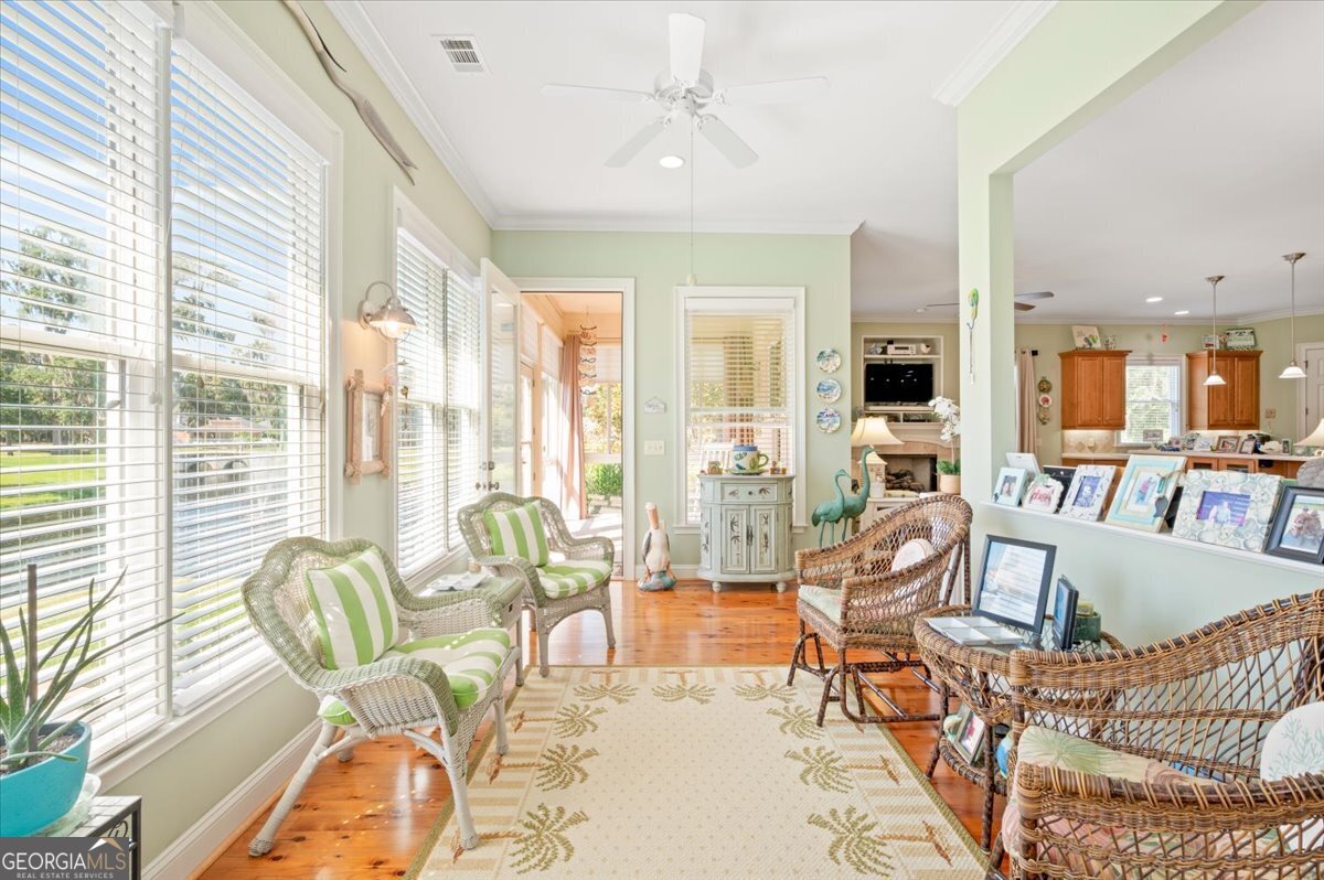 4787 Sunbury Road Midway, GA 31320 - Photo 31 of 72 a living room with furniture and floor to ceiling windows