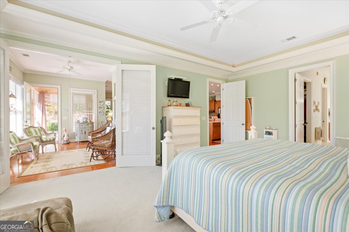 4787 Sunbury Road Midway, GA 31320 - Photo 32 of 72 a bedroom with a bed and a large mirror