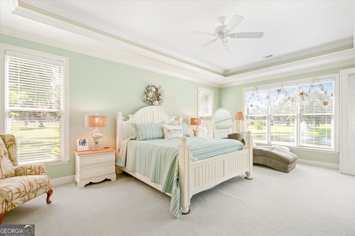 4787 Sunbury Road Midway, GA 31320 - Photo 33 of 72 a spacious bedroom with a bed and a large window with the outer view