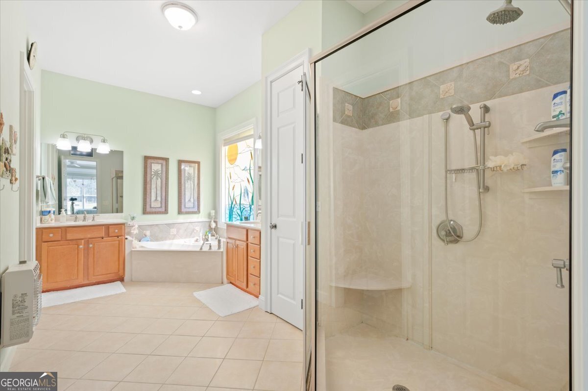 4787 Sunbury Road Midway, GA 31320 - Photo 35 of 72 a bathroom with a tub shower and sink