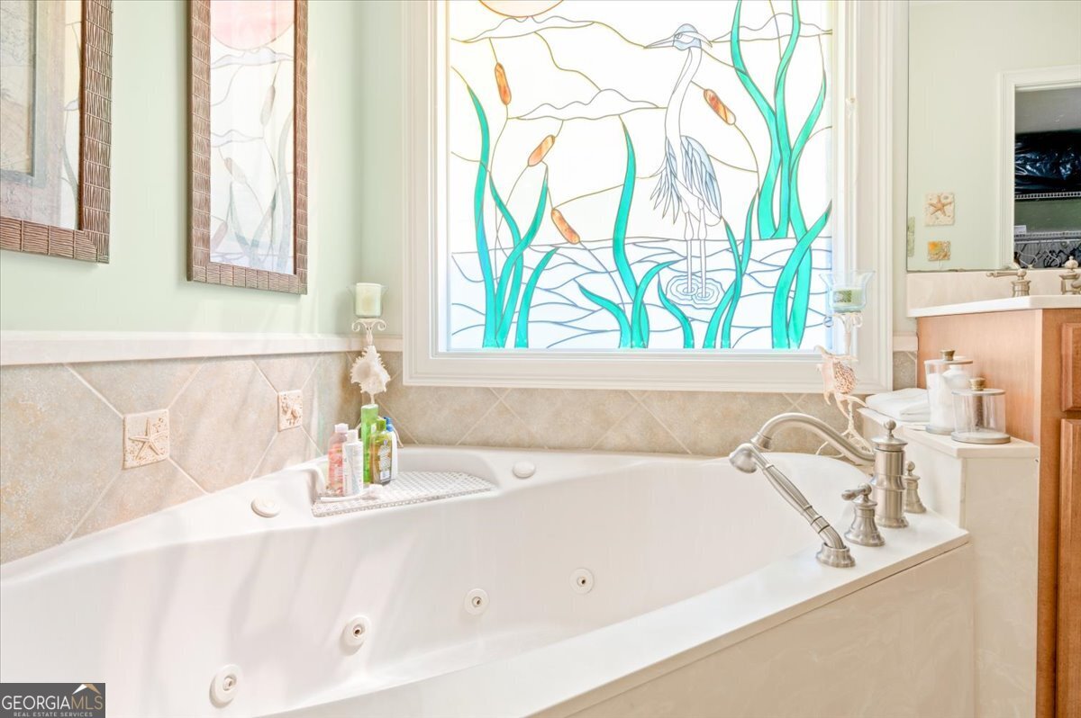 4787 Sunbury Road Midway, GA 31320 - Photo 37 of 72 a bathroom with a tub sink and a window