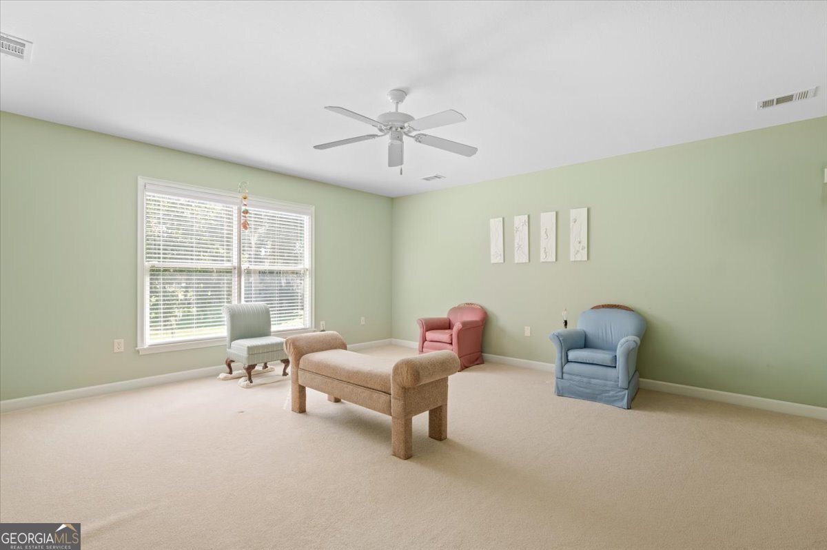 4787 Sunbury Road Midway, GA 31320 - Photo 42 of 72 a living room with furniture and a window