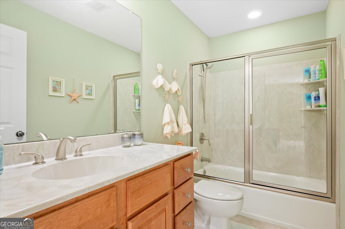 4787 Sunbury Road Midway, GA 31320 - Photo 46 of 72 a bathroom with a granite countertop sink toilet and shower