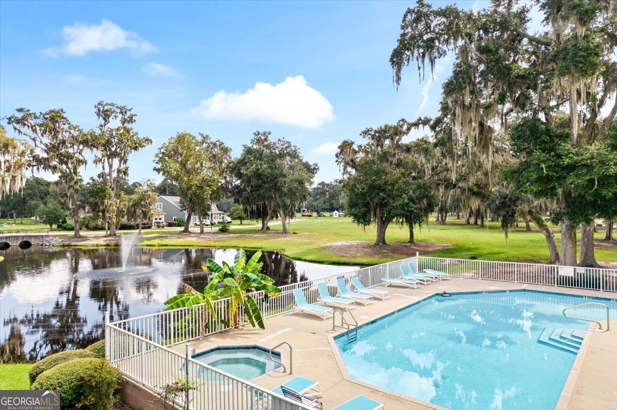 4787 Sunbury Road Midway, GA 31320 - Photo 62 of 72 a view of a swimming pool with a patio and a yard
