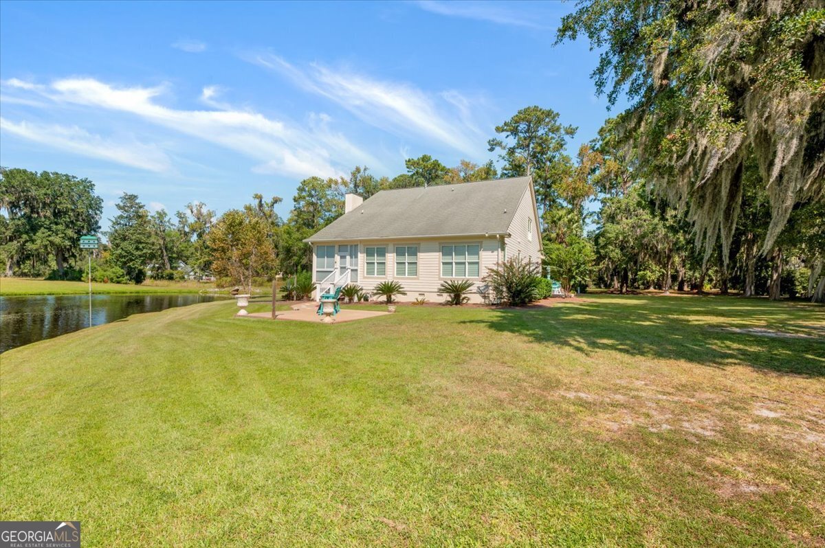 4787 Sunbury Road Midway, GA 31320 - Photo 9 of 72 a front view of a house with swimming pool having outdoor seating