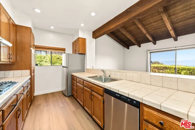 a spacious bedroom with a bed and a wooden floor