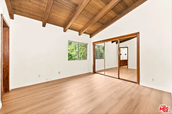 a spacious bathroom with a tub shower and mirror