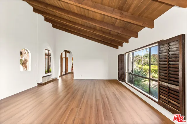 a view of a kitchen with a sink and wooden floor