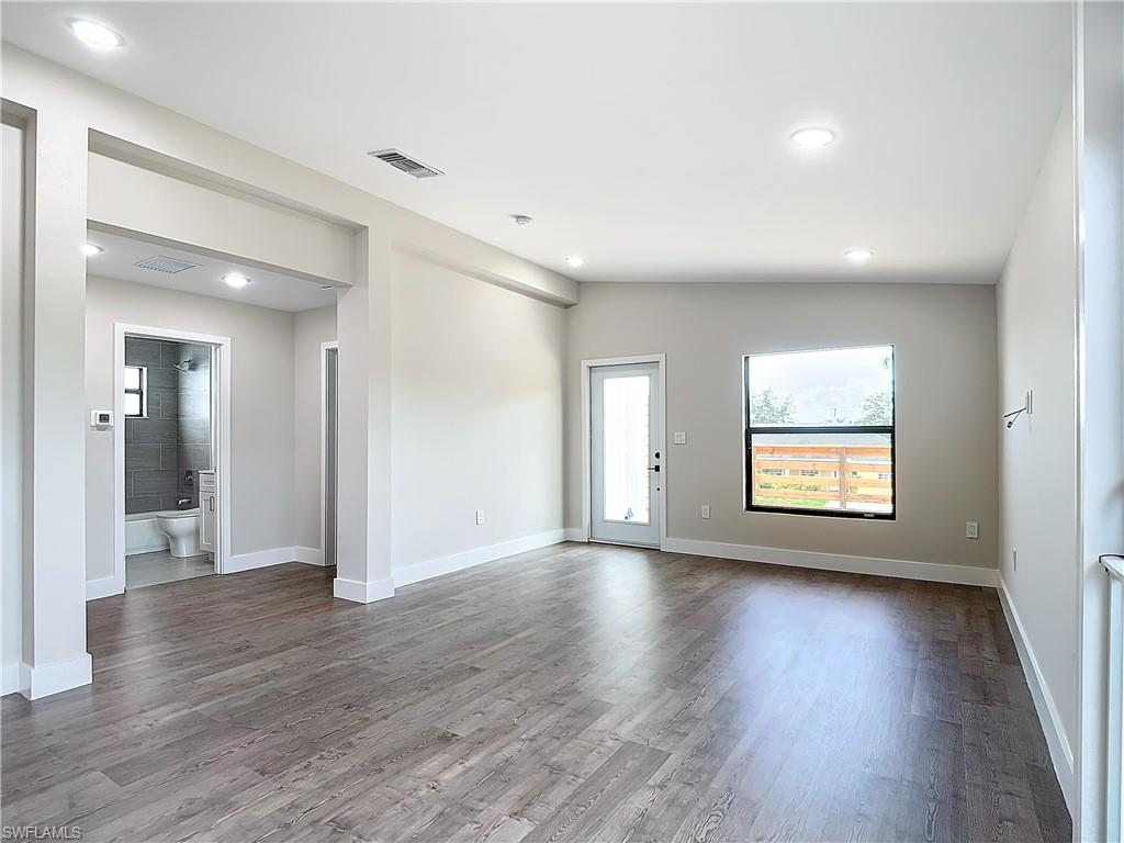 2505 Storter Avenue Naples, FL 34112 - Photo 11 of 49 wooden floor in an empty room with a window
