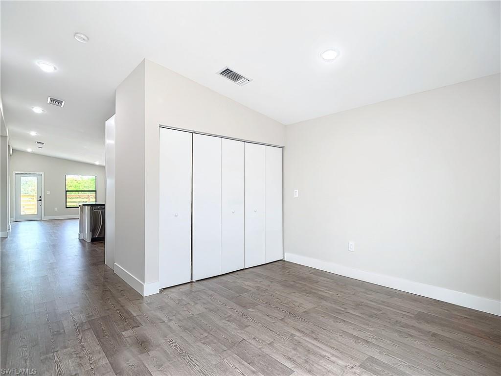 2505 Storter Avenue Naples, FL 34112 - Photo 18 of 49 a view of a hallway with wooden floor