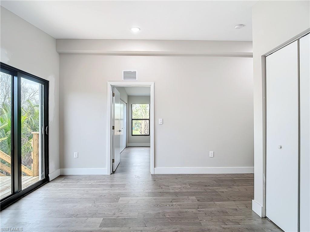 2505 Storter Avenue Naples, FL 34112 - Photo 21 of 49 a view of empty room with wooden floor and fan