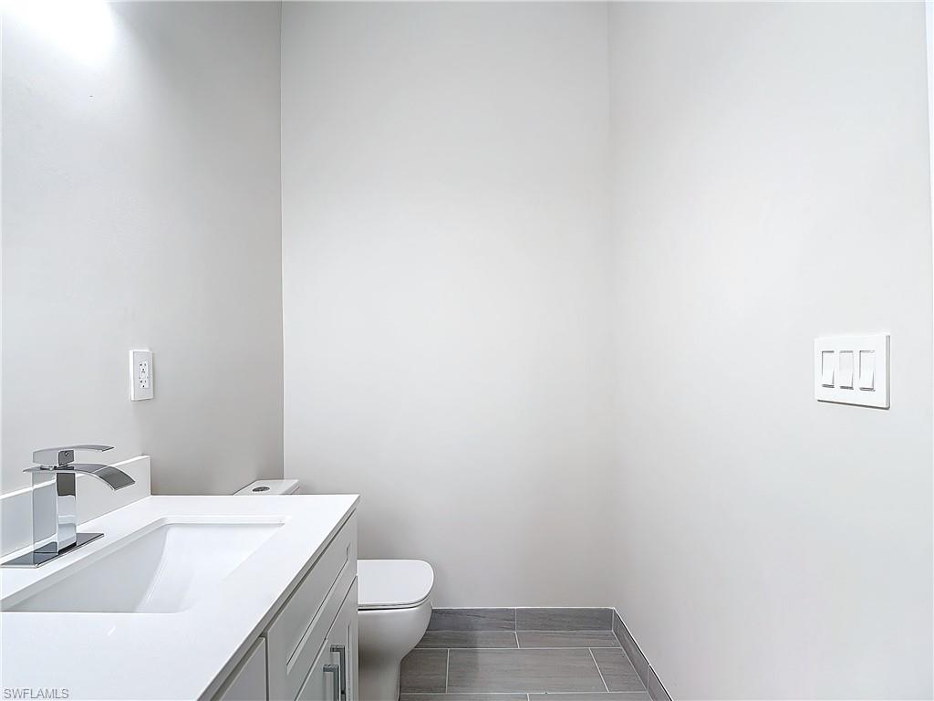 2505 Storter Avenue Naples, FL 34112 - Photo 25 of 49 a bathroom with a sink and a toilet