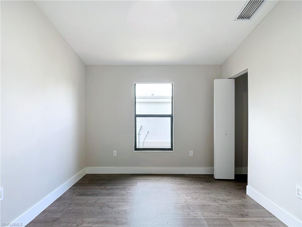 2505 Storter Avenue Naples, FL 34112 - Photo 28 of 49 an empty room with windows and closet