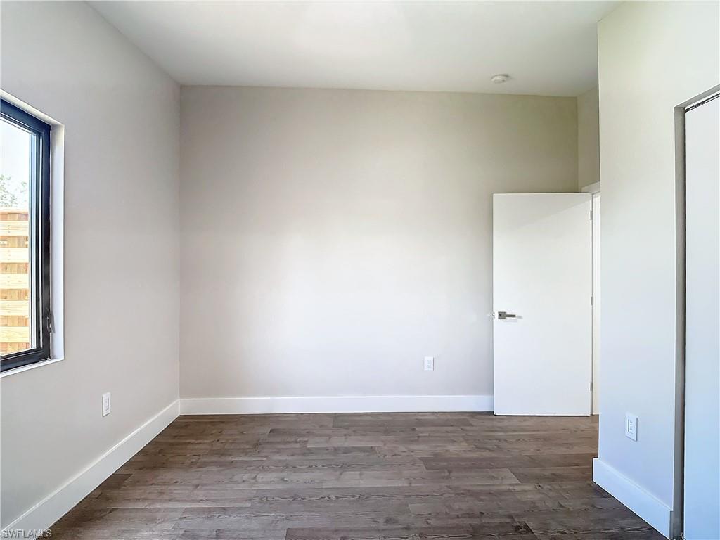 2505 Storter Avenue Naples, FL 34112 - Photo 33 of 49 a view of an empty room with wooden floor and a window