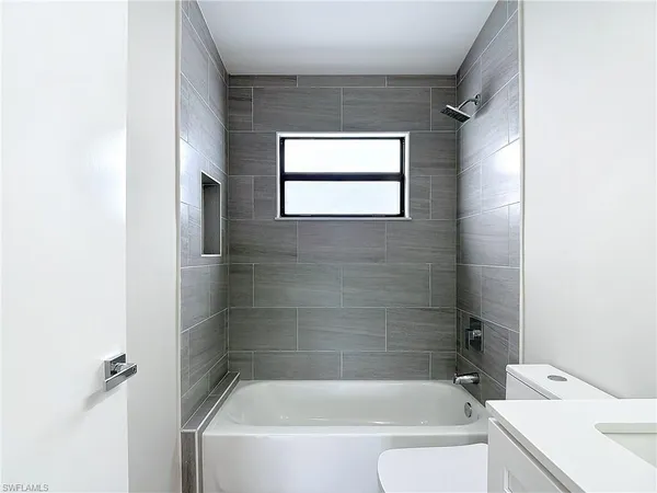 a white bath tub sitting next to a white sink