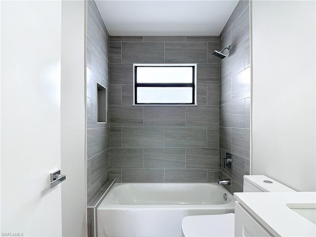 2505 Storter Avenue Naples, FL 34112 - Photo 35 of 49 a white bath tub sitting next to a white sink