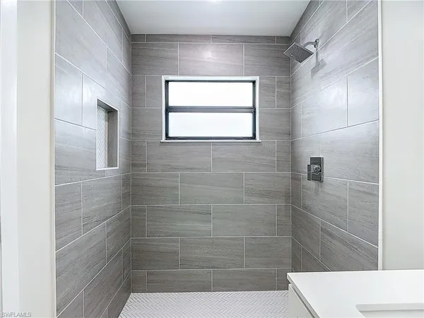 a bathroom with a window and shower