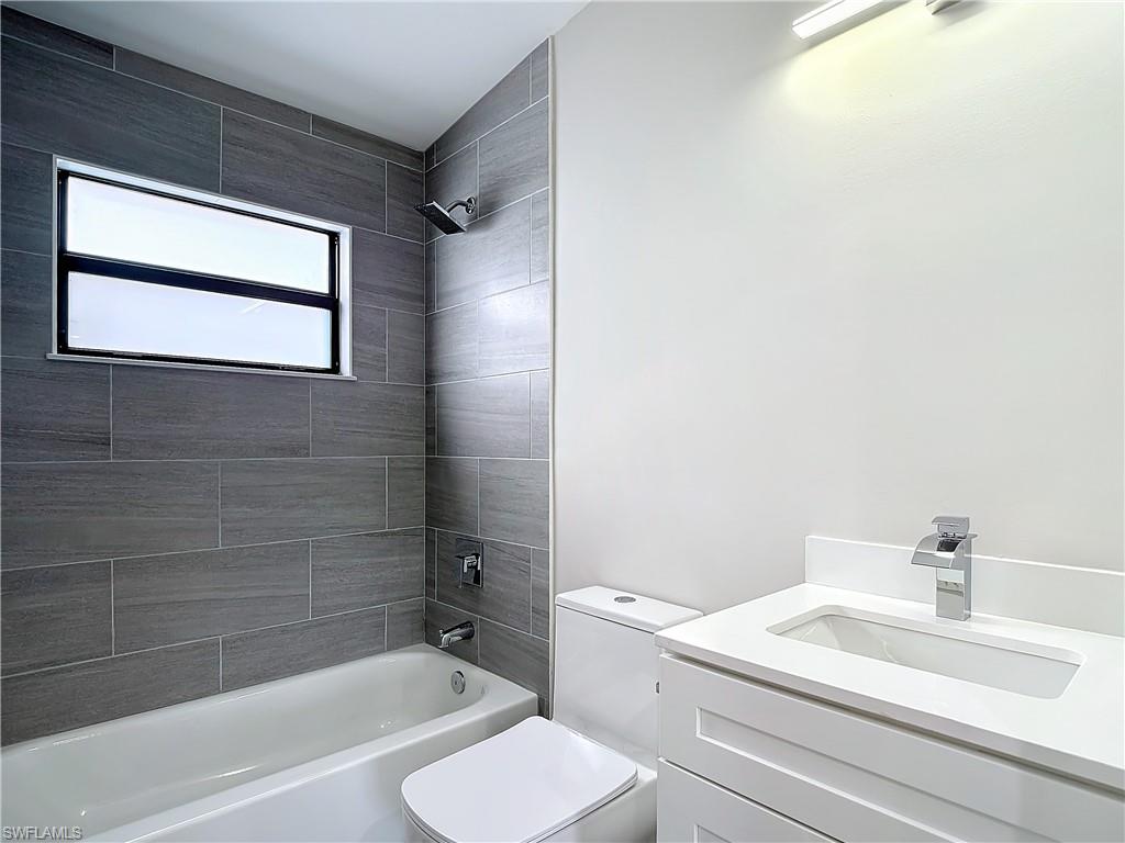 2505 Storter Avenue Naples, FL 34112 - Photo 37 of 49 a bathroom with a sink toilet and shower