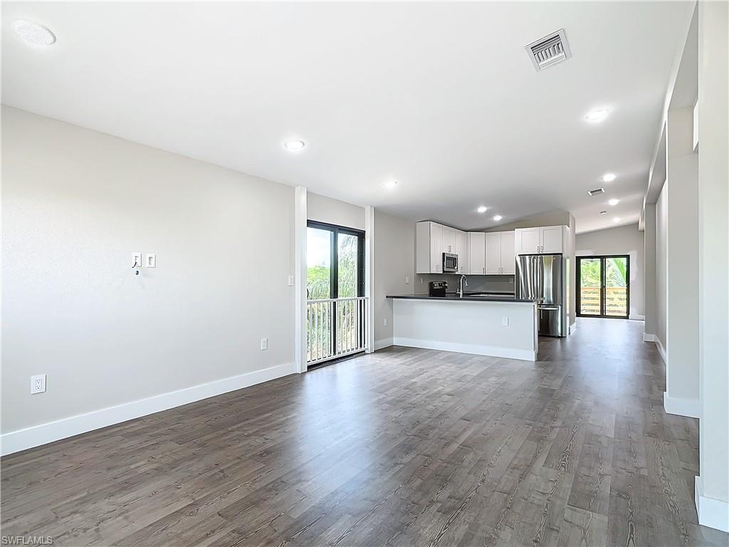 2505 Storter Avenue Naples, FL 34112 - Photo 4 of 49 a view of kitchen with stove and wooden floor