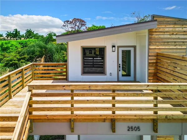 a view of a balcony with wooden floor