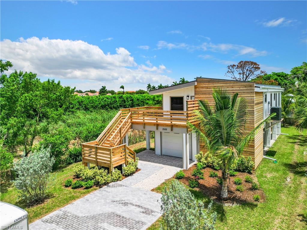 2505 Storter Avenue Naples, FL 34112 - Photo 5 of 49 a front view of a house with a yard