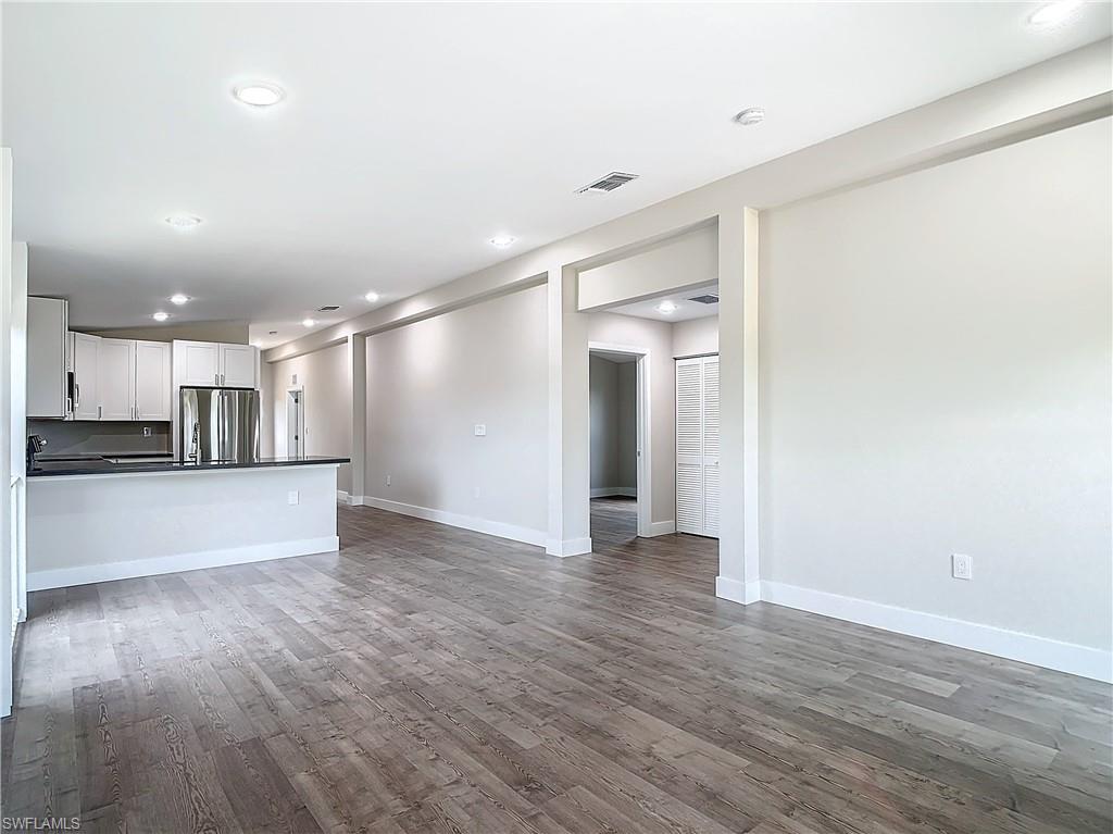 2505 Storter Avenue Naples, FL 34112 - Photo 7 of 49 a view of an empty room with kitchen view and a window