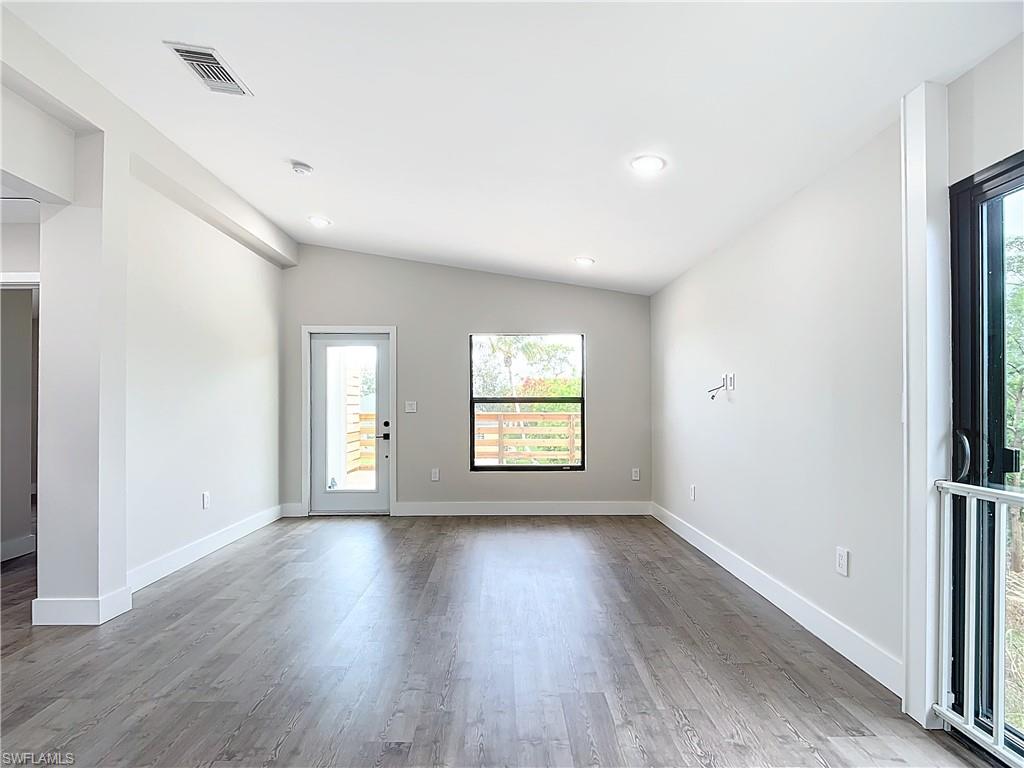 2505 Storter Avenue Naples, FL 34112 - Photo 10 of 49 a view of an empty room with wooden floor and a window
